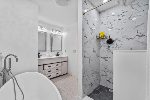 Bathroom, Dual Sink Vanities, Free Standing Baths, Interior, Marble Walls, Wood Texture Flooring