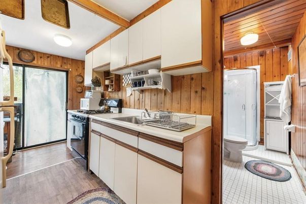 Interior, Kitchen, Tile Countertops, Wood Texture Flooring, Wooden Walls