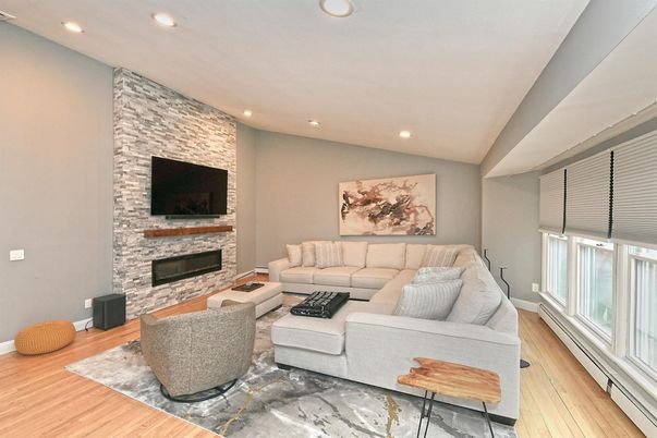 Fireplace, Interior, Living room, Recessed Lighting, Stone Walls, Wood Texture Flooring
