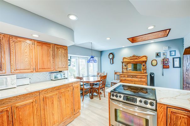 Dining room, Interior, Kitchen, Pendant Lights, Recessed Lighting, Stainless Steel Appliances, Wood Texture Flooring