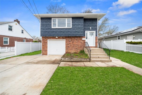 Attached, Exterior, Facade, Brick Facade, Solar Panels, Raised Ranch