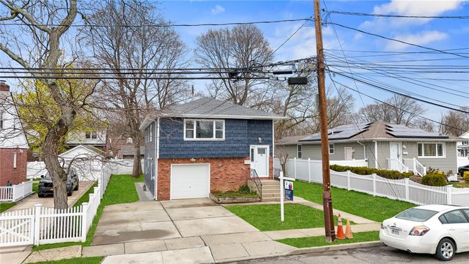 Attached, Exterior, Facade, Brick Facade, Solar Panels, Raised Ranch
