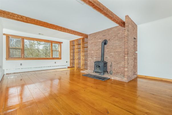 Empty room, Fireplace, Interior, Stone Walls, Wooden Beams, Wood Texture Flooring