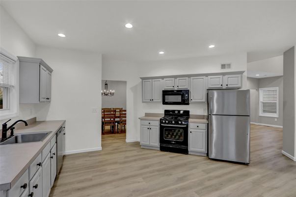 Chandelier, Dining room, Interior, Kitchen, Recessed Lighting, Stainless Steel Appliances, Wood Texture Flooring