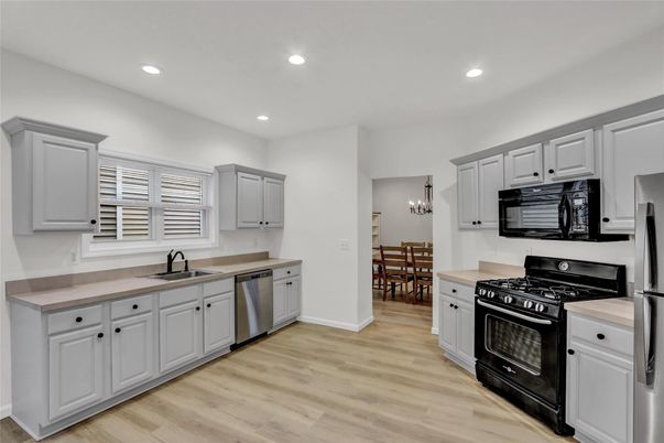 Chandelier, Dining room, Interior, Kitchen, Recessed Lighting, Stainless Steel Appliances, Wood Texture Flooring