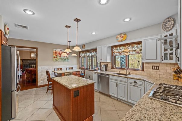 Dining room, Interior, Kitchen, Pendant Lights, Recessed Lighting, Stainless Steel Appliances, Wood Texture Flooring