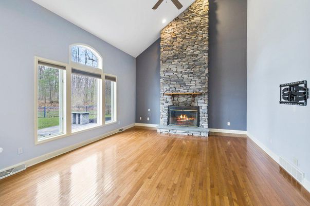 Empty room, Fireplace, Interior, Recessed Lighting, Stone Walls, Wood Texture Flooring