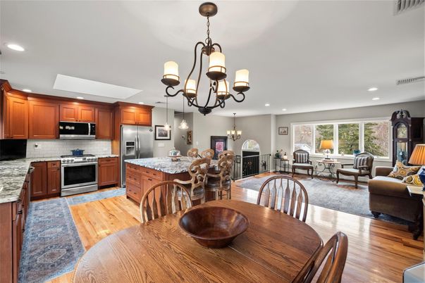 Chandelier, Dining room, Fireplace, Interior, Kitchen, Living room, Recessed Lighting, Stainless Steel Appliances, Wood Texture Flooring