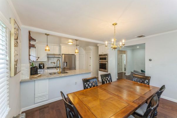 Chandelier, Dining room, Interior, Kitchen, Pendant Lights, Stainless Steel Appliances, Wood Texture Flooring