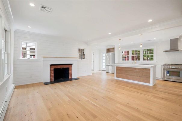 Empty room, Fireplace, Interior, Kitchen, Pendant Lights, Recessed Lighting, Stainless Steel Appliances, Wood Texture Flooring