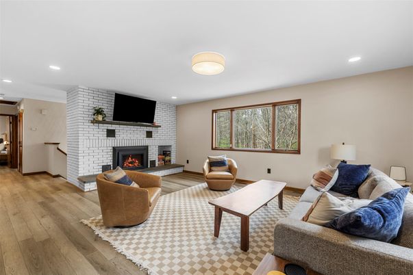 Fireplace, Interior, Living room, Recessed Lighting, Stone Walls, Wood Texture Flooring