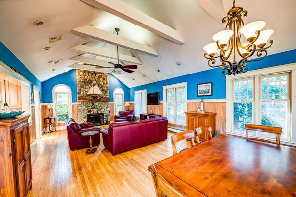 Chandelier, Dining room, Fireplace, Interior, Living room, Stone Walls, Wood Texture Flooring