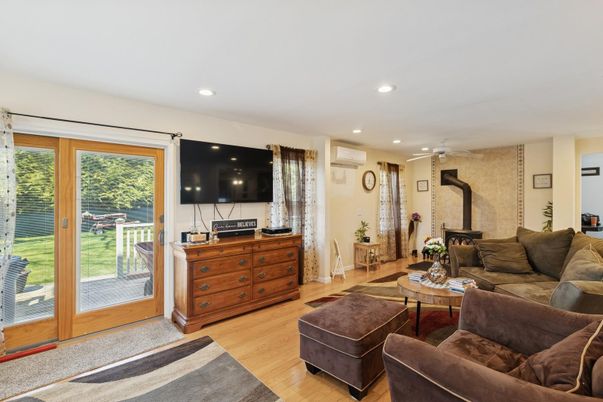 Fireplace, Interior, Living room, Recessed Lighting, Stone Walls, Wood Texture Flooring