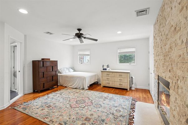Bedroom, Fireplace, Interior, Recessed Lighting, Stone Walls, Wood Texture Flooring