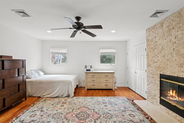 Bedroom, Fireplace, Interior, Recessed Lighting, Stone Walls, Wood Texture Flooring