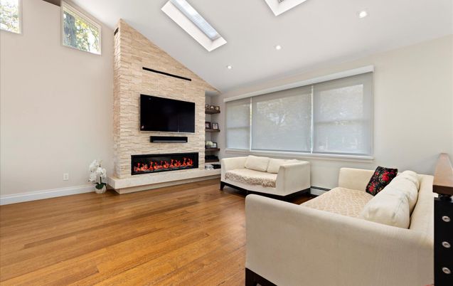 Fireplace, Interior, Living room, Recessed Lighting, Stone Walls, Wood Texture Flooring