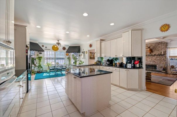Dining room, Fireplace, Interior, Kitchen, Recessed Lighting, Stone Walls, Wood Texture Flooring
