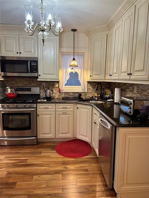 Chandelier, Interior, Kitchen, Pendant Lights, Stainless Steel Appliances, Wood Texture Flooring