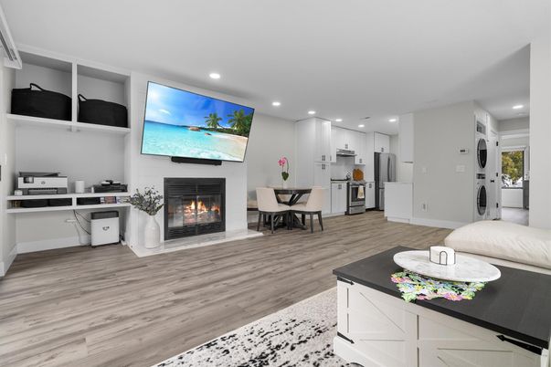 Dining room, Fireplace, Interior, Kitchen, Recessed Lighting, Stainless Steel Appliances, Wood Texture Flooring