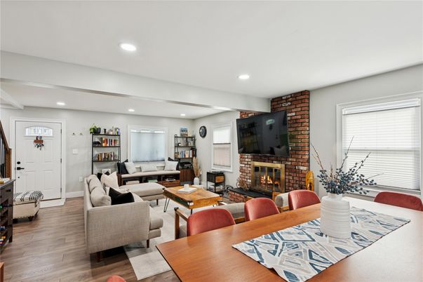 Dining room, Fireplace, Interior, Living room, Recessed Lighting, Stone Walls, Wood Texture Flooring