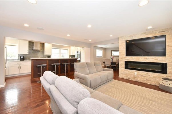Dining room, Fireplace, Interior, Kitchen, Living room, Recessed Lighting, Stainless Steel Appliances, Stone Walls, Wood Texture Flooring