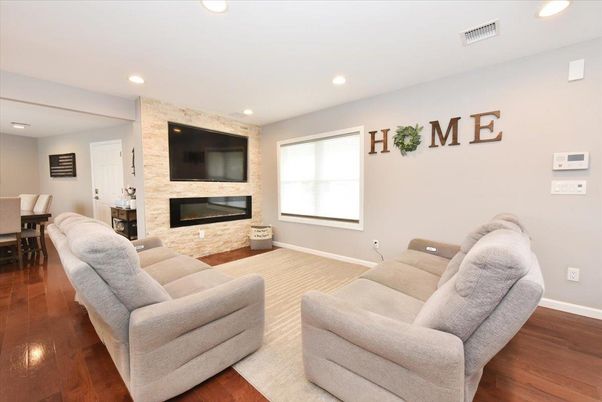 Dining room, Fireplace, Interior, Living room, Recessed Lighting, Stone Walls, Wood Texture Flooring