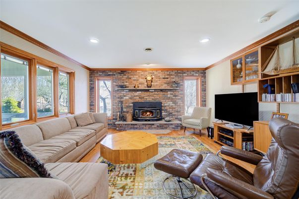 Fireplace, Interior, Living room, Recessed Lighting, Stone Walls, Wood Texture Flooring