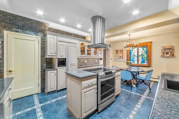 Chandelier, Dining room, Interior, Kitchen, Pendant Lights, Recessed Lighting, Stainless Steel Appliances, Stone Walls