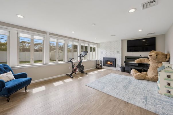 Fireplace, Fitness Equipment, Interior, Living room, Recessed Lighting, Wood Texture Flooring
