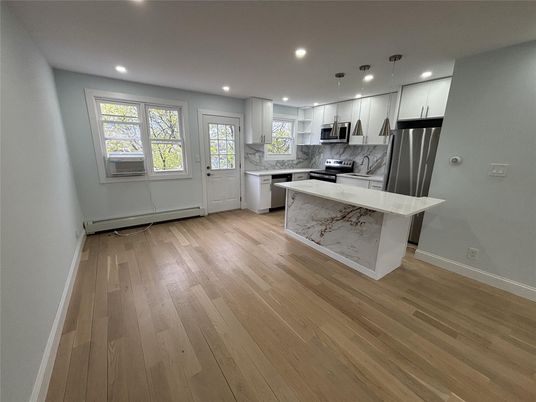 Interior, Kitchen, Marble Walls, Pendant Lights, Recessed Lighting, Stainless Steel Appliances, Wood Texture Flooring