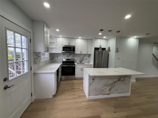 Interior, Kitchen, Marble Walls, Recessed Lighting, Stainless Steel Appliances, Wood Texture Flooring