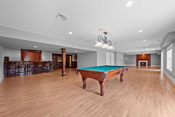 Billiard Table, Chandelier, Fireplace, Game Room, Interior, Recessed Lighting, Wood Texture Flooring