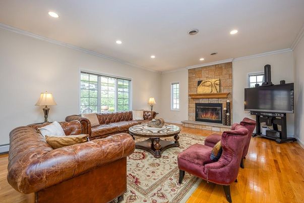 Fireplace, Interior, Living room, Recessed Lighting, Stone Walls, Wood Texture Flooring