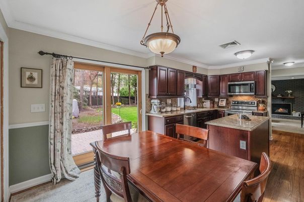 Dining room, Fireplace, Interior, Kitchen, Pendant Lights, Stainless Steel Appliances, Wood Texture Flooring