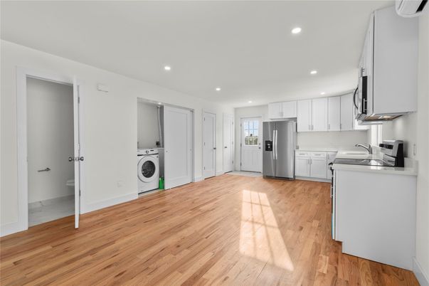 Interior, Kitchen, Recessed Lighting, Washer, Wood Texture Flooring