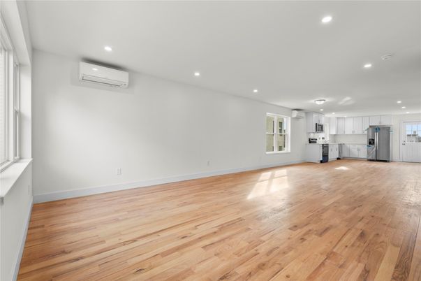 Empty room, Interior, Kitchen, Recessed Lighting, Stainless Steel Appliances, Wood Texture Flooring