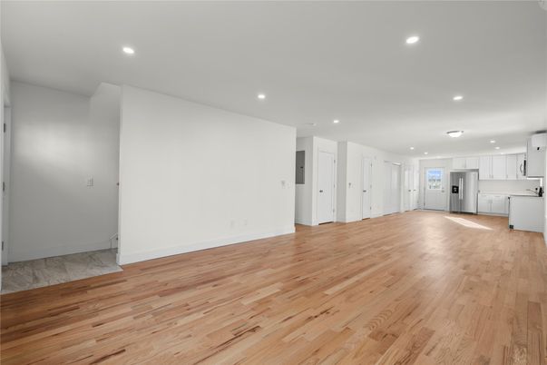 Empty room, Interior, Kitchen, Recessed Lighting, Stainless Steel Appliances, Wood Texture Flooring