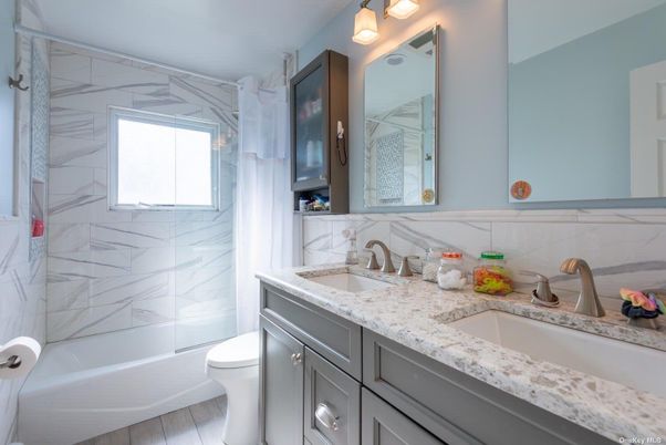 Bathroom, Dual Sink Vanities, Interior, Marble Walls, Wood Texture Flooring