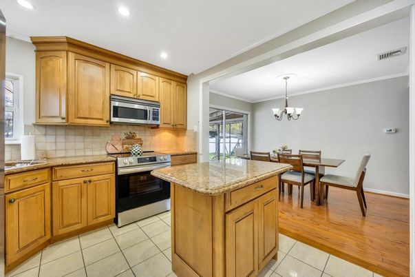Chandelier, Dining room, Interior, Kitchen, Recessed Lighting, Stainless Steel Appliances, Wood Texture Flooring