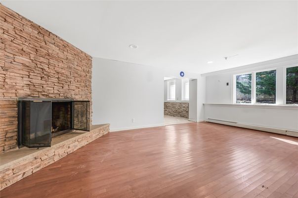 Empty room, Fireplace, Interior, Recessed Lighting, Stone Walls, Wood Texture Flooring