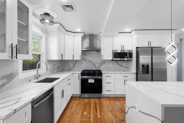 Interior, Kitchen, Marble Walls, Recessed Lighting, Stainless Steel Appliances, Wood Texture Flooring