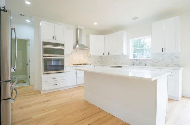 Interior, Kitchen, Marble Walls, Recessed Lighting, Stainless Steel Appliances, Wood Texture Flooring