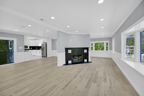 Empty room, Fireplace, Interior, Kitchen, Recessed Lighting, Stainless Steel Appliances, Wood Texture Flooring