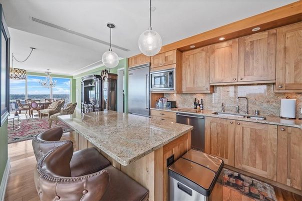 Chandelier, Dining room, Interior, Kitchen, Living room, Pendant Lights, Recessed Lighting, Stainless Steel Appliances, Wood Texture Flooring