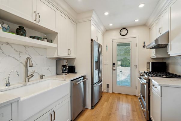 Interior, Kitchen, Marble Walls, Recessed Lighting, Stainless Steel Appliances, Wood Texture Flooring