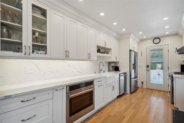 Interior, Kitchen, Marble Walls, Recessed Lighting, Stainless Steel Appliances, Wood Texture Flooring