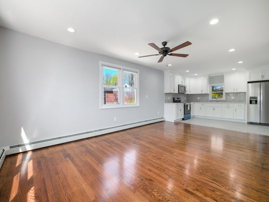 Empty room, Interior, Kitchen, Recessed Lighting, Stainless Steel Appliances, Wood Texture Flooring