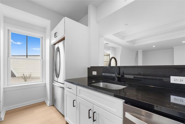 Interior, Kitchen, Recessed Lighting, Washer, Wood Texture Flooring