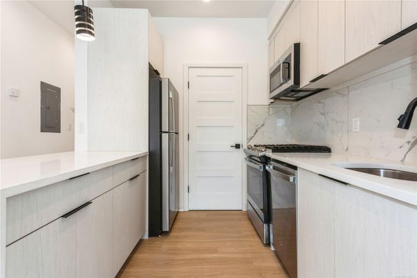 Interior, Kitchen, Marble Walls, Recessed Lighting, Stainless Steel Appliances, Wood Texture Flooring