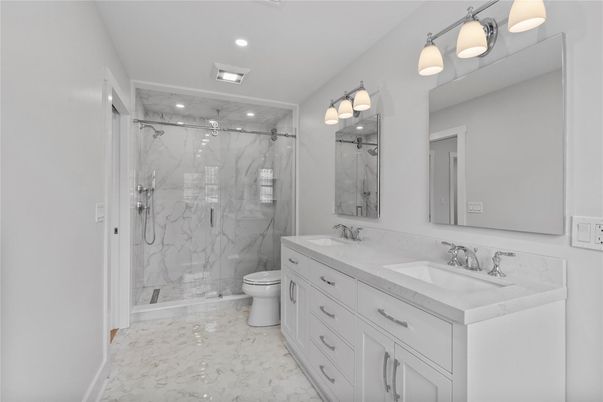 Bathroom, Dual Sink Vanities, Glass Shower, Interior, Marble, Marble Walls, Recessed Lighting